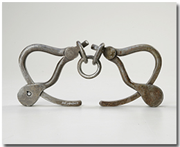 Handcuffs worn to the gallows by Louis Riel, and the robe worn by the judge who presided over his trial.
CWM, 20030122.004
