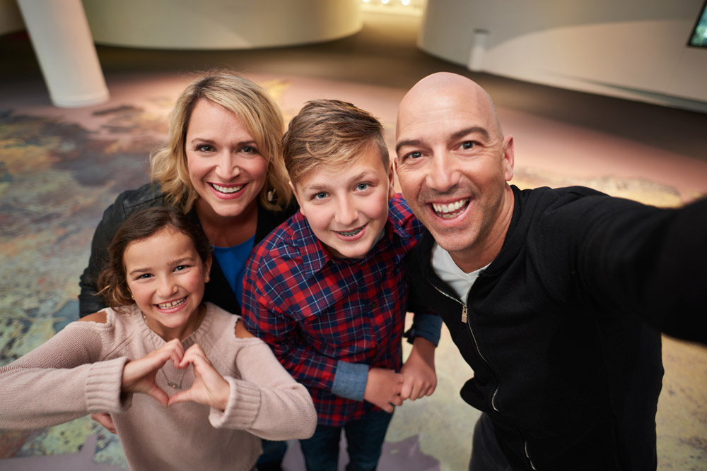 Close-up view of a family smiling in the History Hall