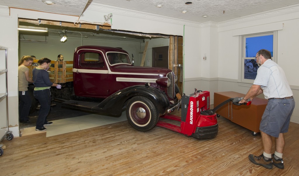 Collections specialists moving the Dodge Fargo pickup truck out of the Canada Hall using the modified route.