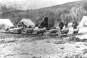 People in a mining town, with a sled in the foreground