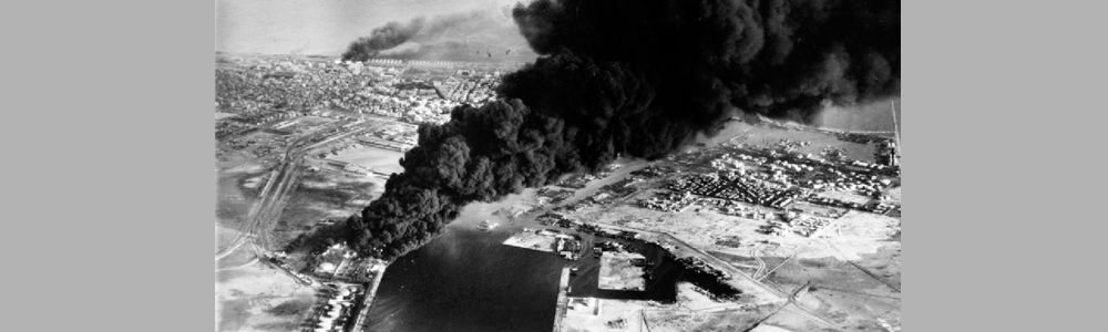 Smoke rises from oil tanks beside the Suez Canal
