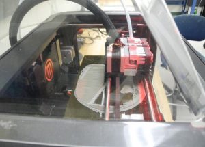 3D printer replicating the skull in plastic 