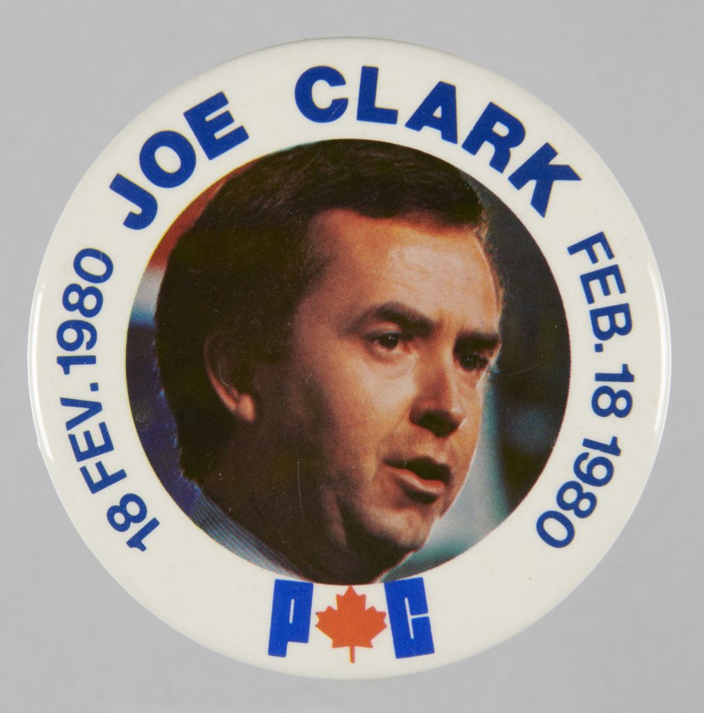 White campaign button with an image of Joe Clark, along with his name and the date FEB.17 1980 and 16 FEV. 1980