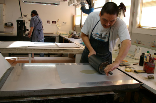 Printmaker Niviaqsi Quvianaqtuliaq creating a lithograph proof for, “Halibut,” by Ningeokuluk Teevee