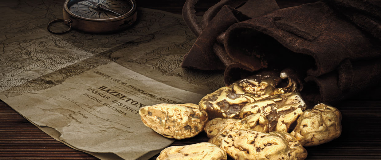 Gold truffles on a wooden table with a compass.