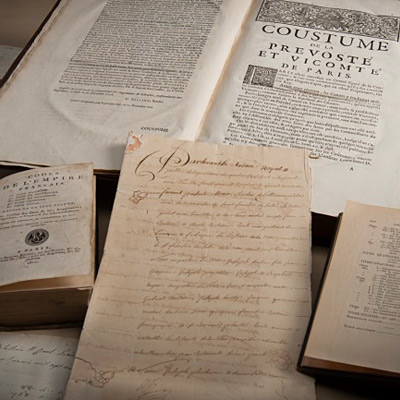 A collection of books and manuscripts from the Canadian Museum of History in Ottawa, displayed on a table.