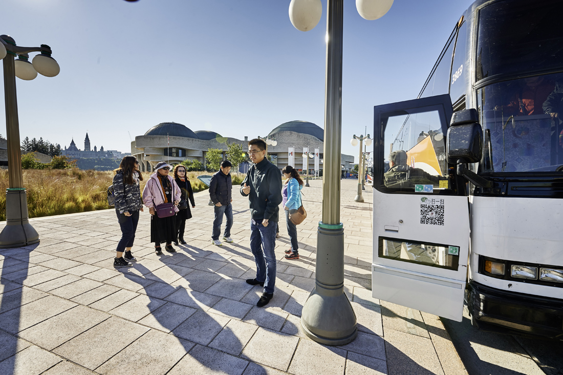 Visitors at the Canadian Museum of History in Ottawa boarding a bus.