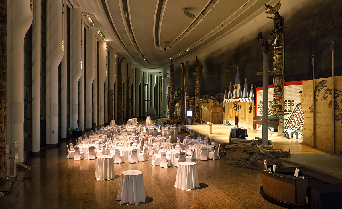 A large room with white tables and chairs in the Canadian Museum of History.