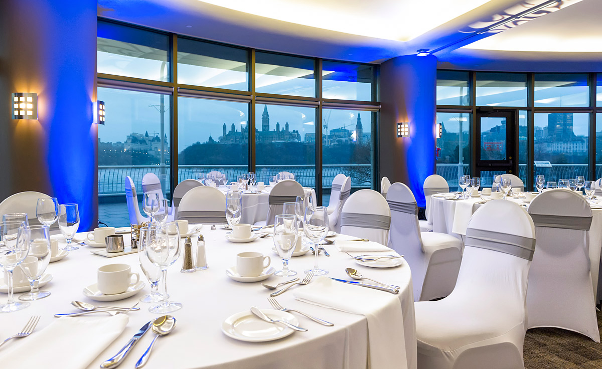 A large room with tables and chairs set up in front of a large window at the Canadian Museum of History in Ottawa.