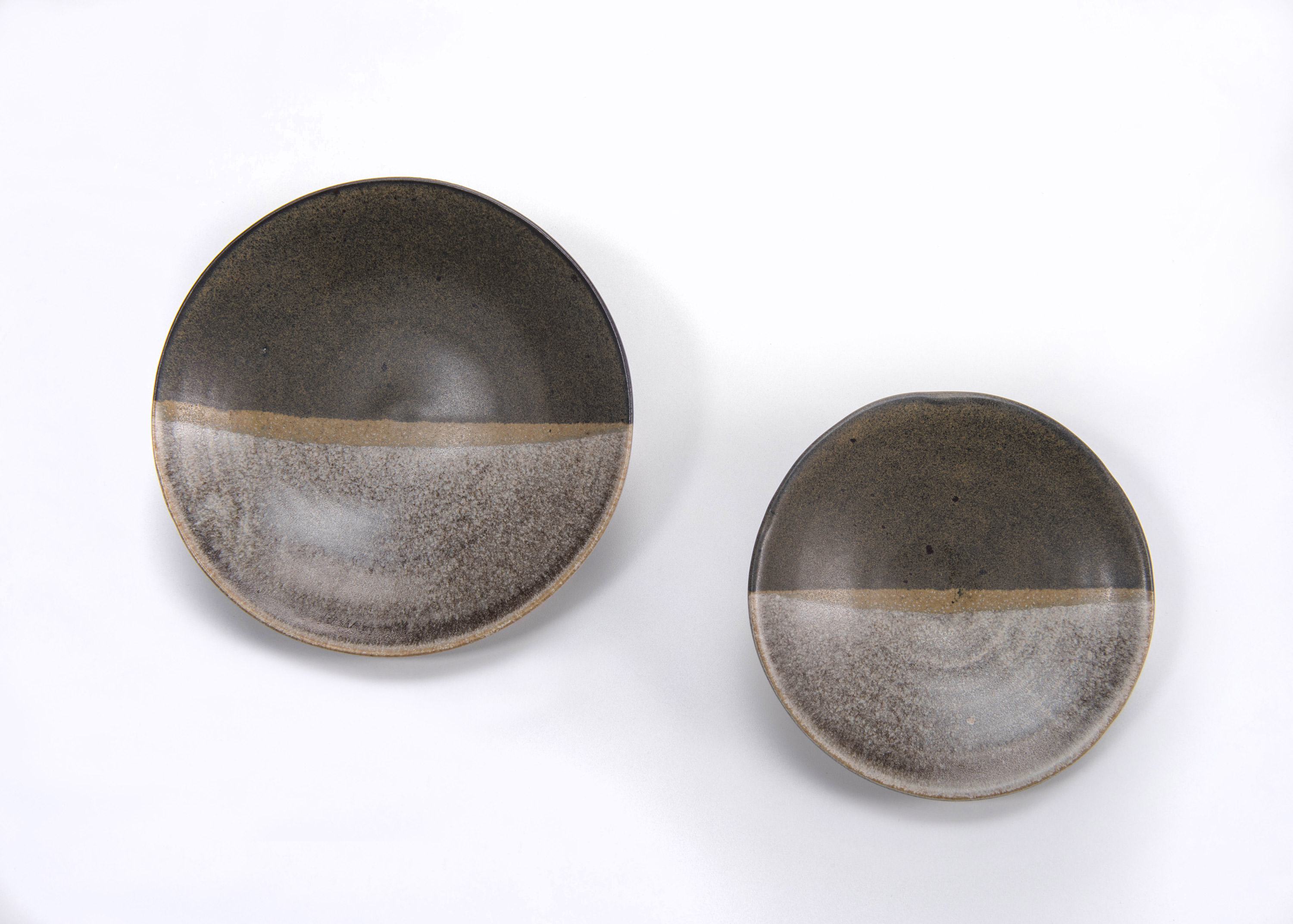 Two grey and brown bowls on a white surface at the Canadian Museum of History in Ottawa.