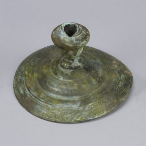 Bronze candlestick with a patina and a round base