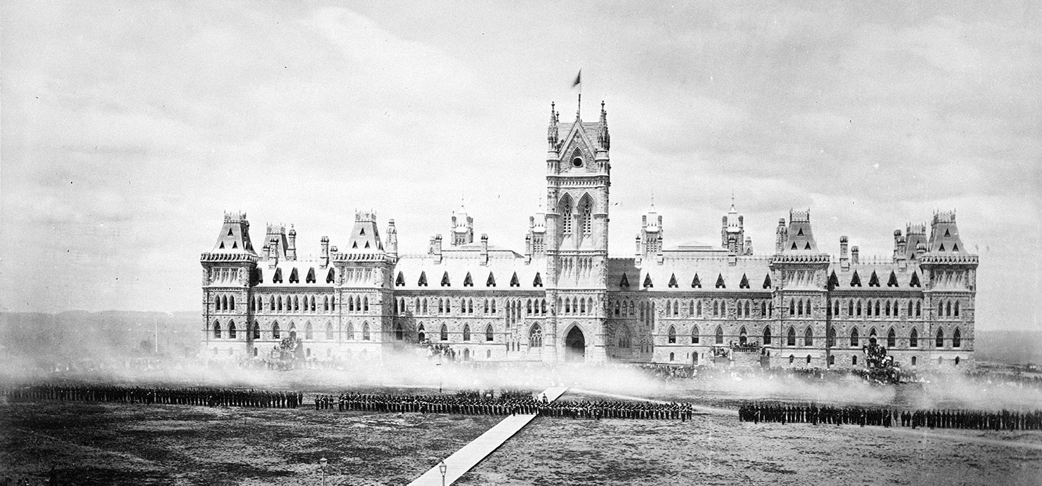 An old photo of the Canadian Museum of History in Ottawa with smoke coming out of it.