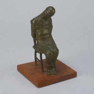 Sculpture depicting a man bound to a chair