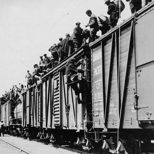 Men climbing onto freight cars