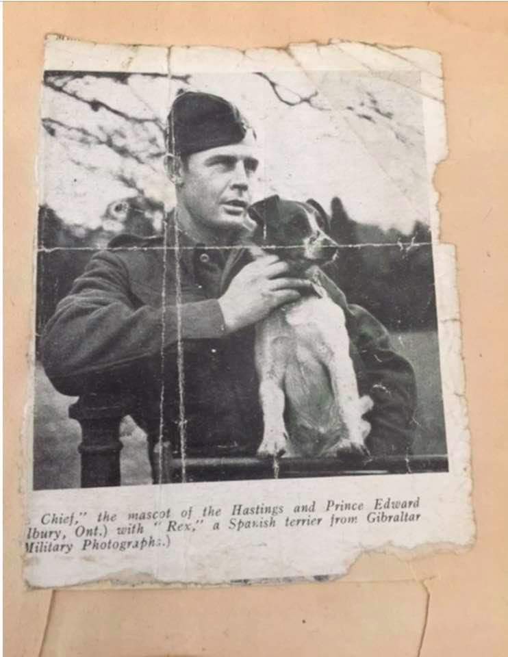 Francis Sullivan in uniform with a dog.