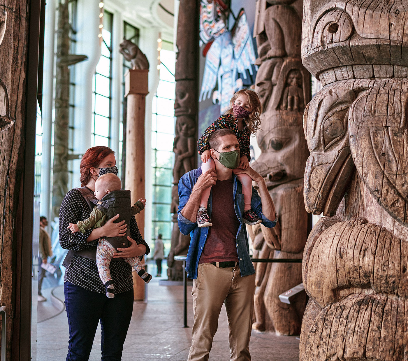 A family is standing in front of totem poles at the Canadian Museum of History in Ottawa.