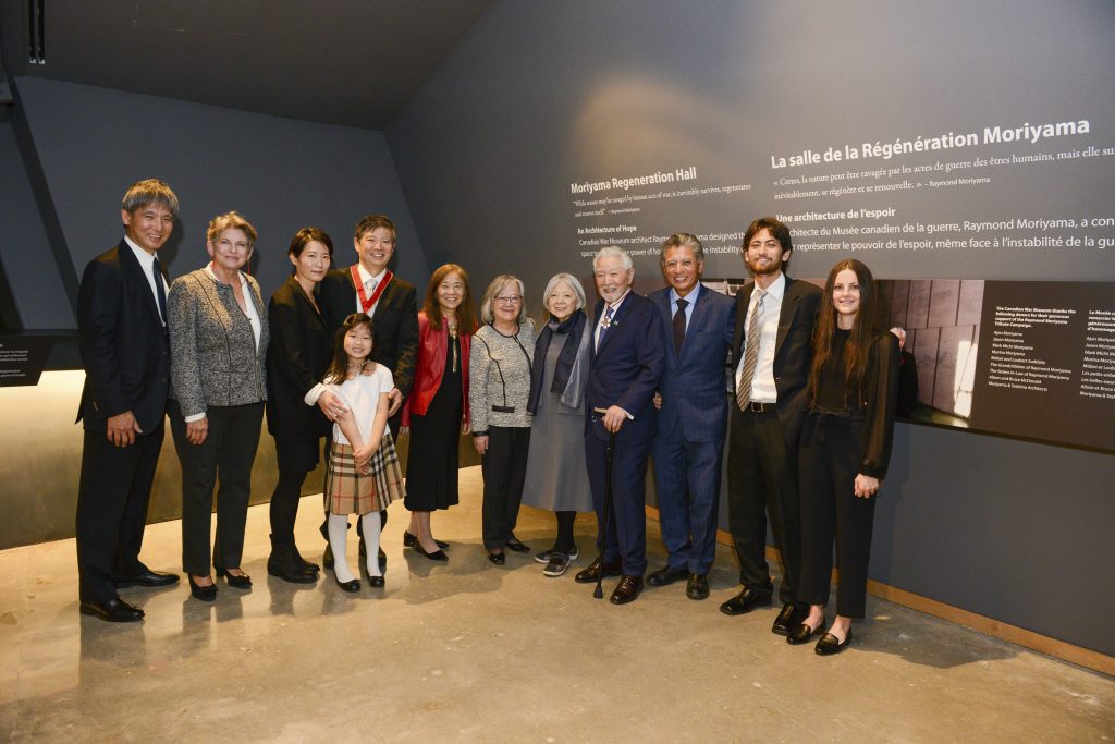 The Moriyama family stands proudly in the Moriyama Regeneration Hall.