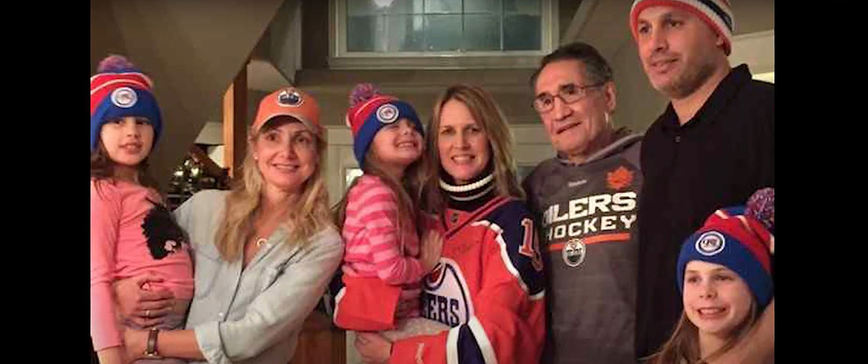 A family posing for a photo in a Canadian Museum of History hockey hat in Ottawa.