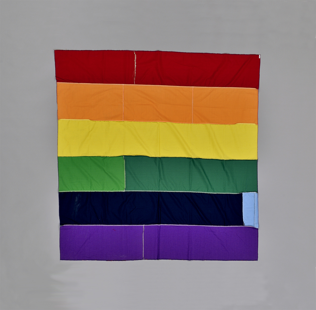 An image of a rainbow flag in Ottawa, against a gray background