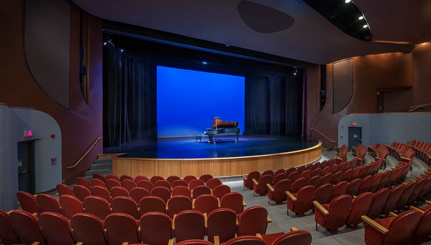 The Canadian Museum of History in Ottawa features an auditorium with red chairs and a piano.