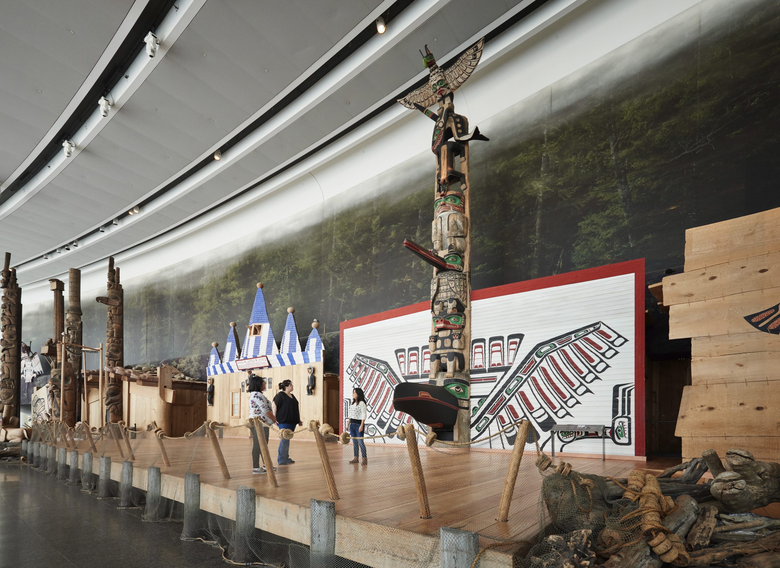 Visitors at the Canadian Museum of History in Ottawa admiring a display of totem poles.