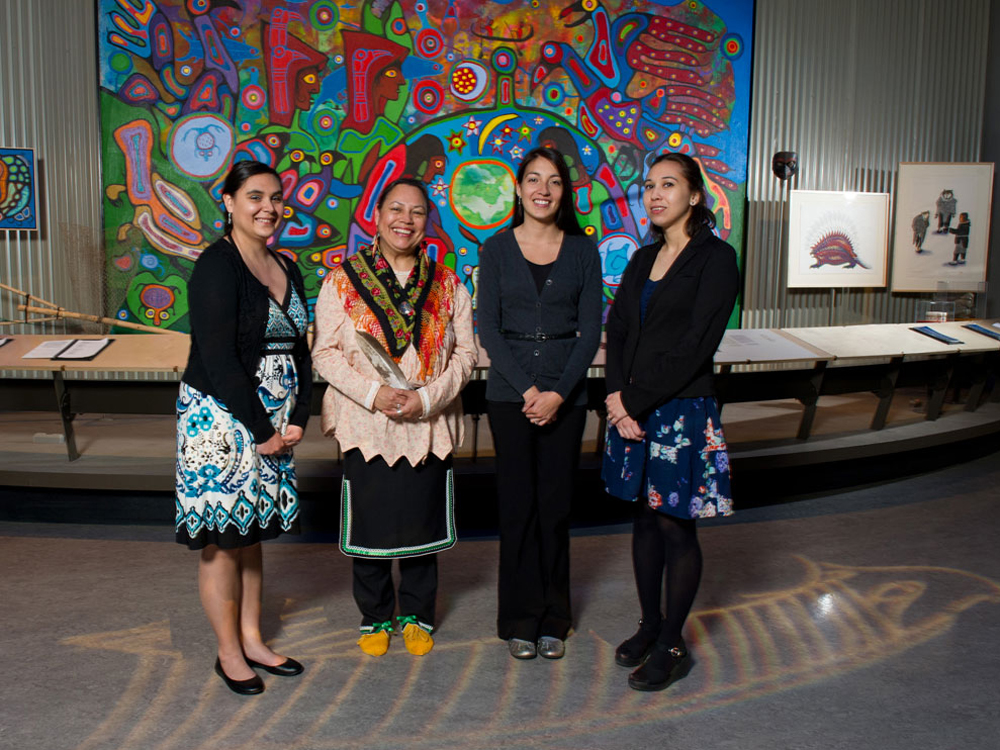 Four women standing in front of a painting at the Canadian Museum of History in Ottawa.