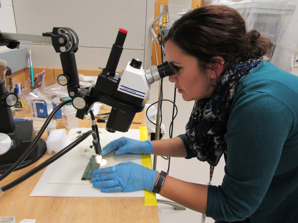 A woman looking through a microscope at the Canadian Museum of History in Ottawa.