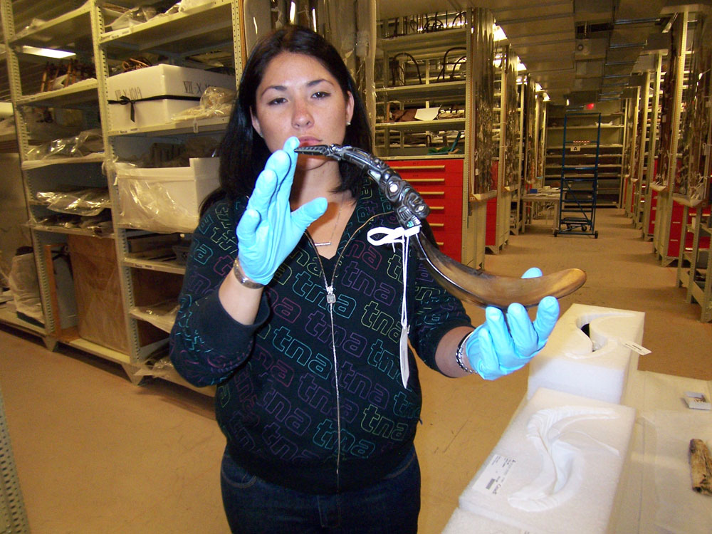 A woman holding a horn in the Canadian Museum of History in Ottawa.