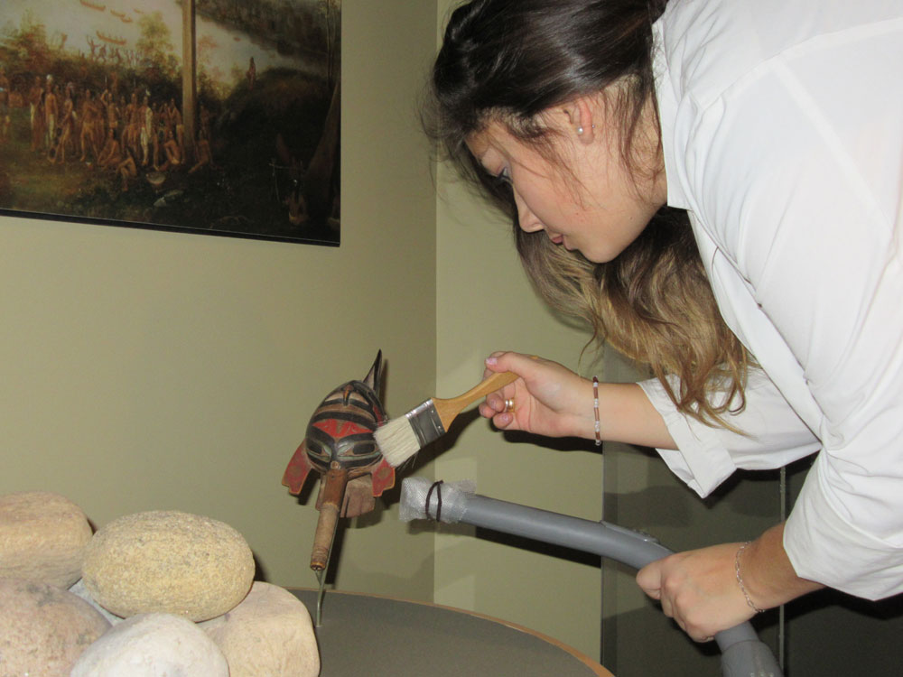 A woman cleaning an artifact from the museum.