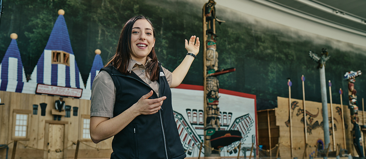 A woman is standing in front of a totem pole at the Canadian Museum of History in Ottawa.