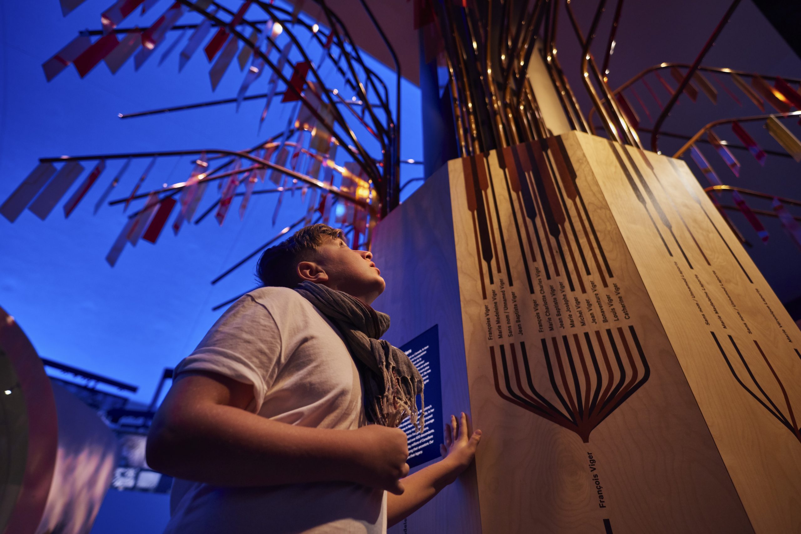 A young boy in Ottawa, Canada, looking at a tall wooden structure at the Canadian Museum of History.