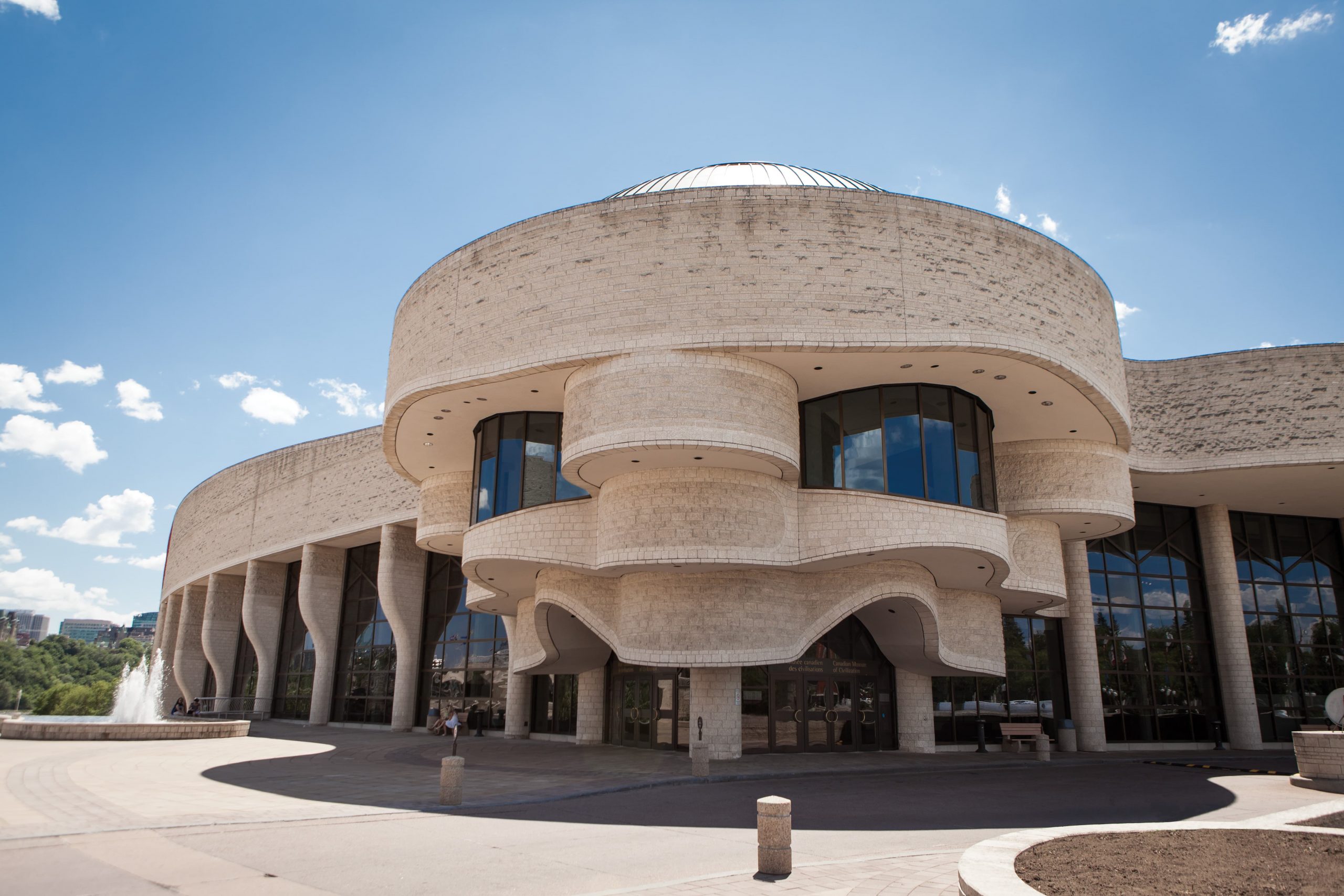 The Canadian Museum of History, located in Ottawa, is a beautiful building with a circular shape in front of it.