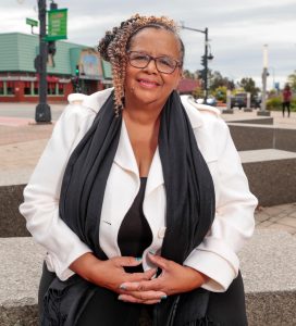 Elizabeth Cooke-Sumbu sitting on a bench.