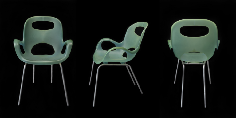 Three green armchairs lined up in a row with the middle one positioned sideways.