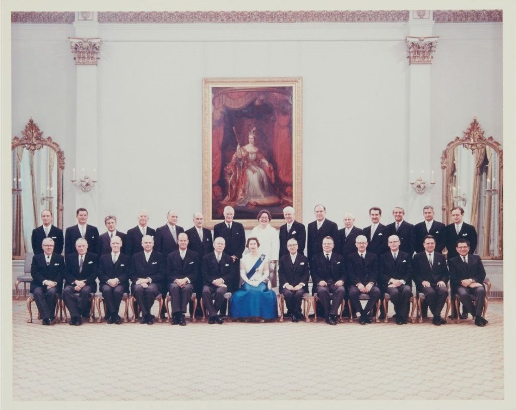 Canada’s Cabinet, July 1, 1967. Queen Elizabeth II and Prime Minister Lester B. Pearson are in the picture along with about 25 ministers in suits