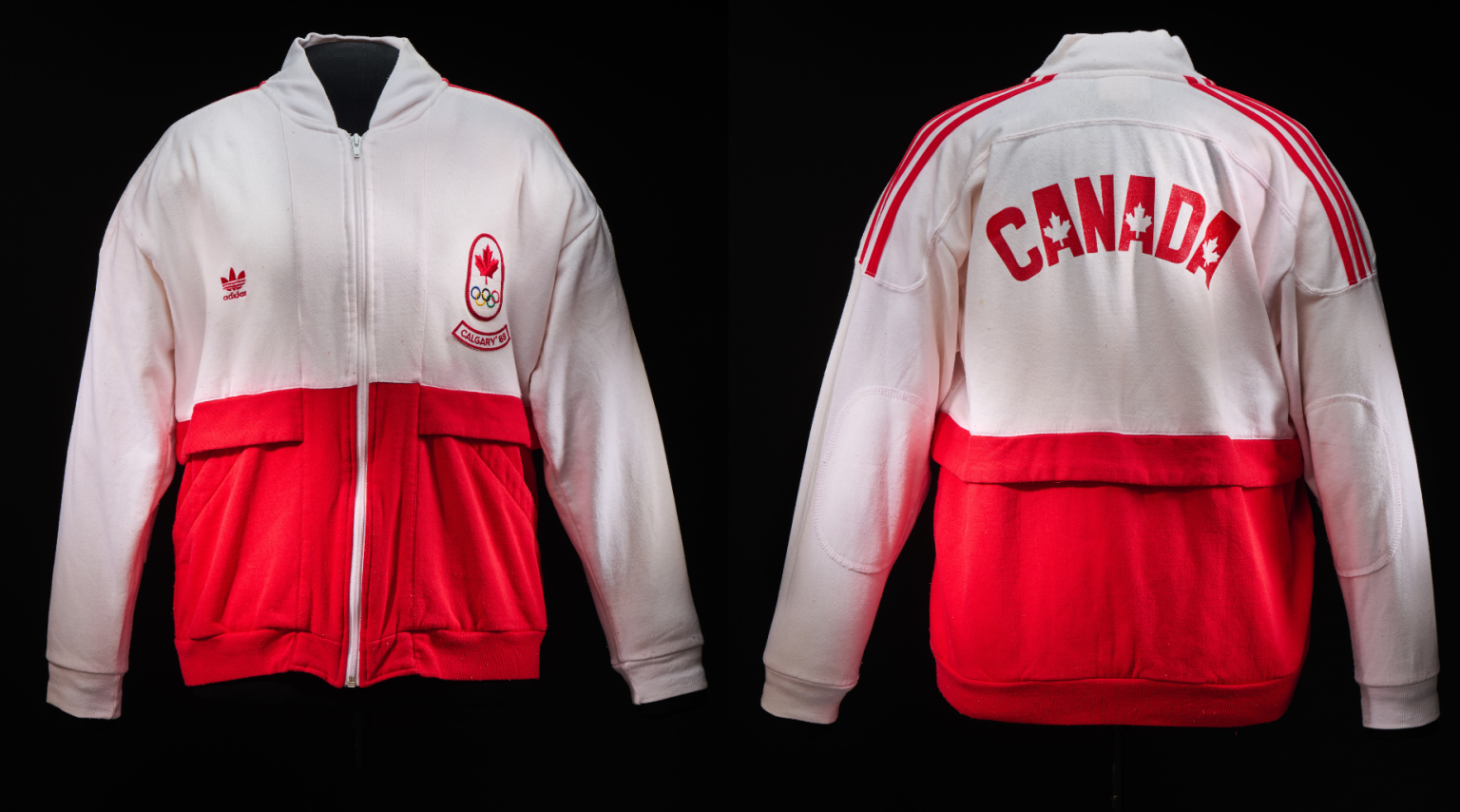 A white and red zip-up jacket with a red maple leaf logo above the Olympic rings logo and the text “Calgary ’88.”