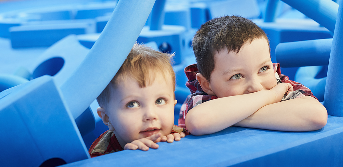 Children with life-sized blue foam blocks