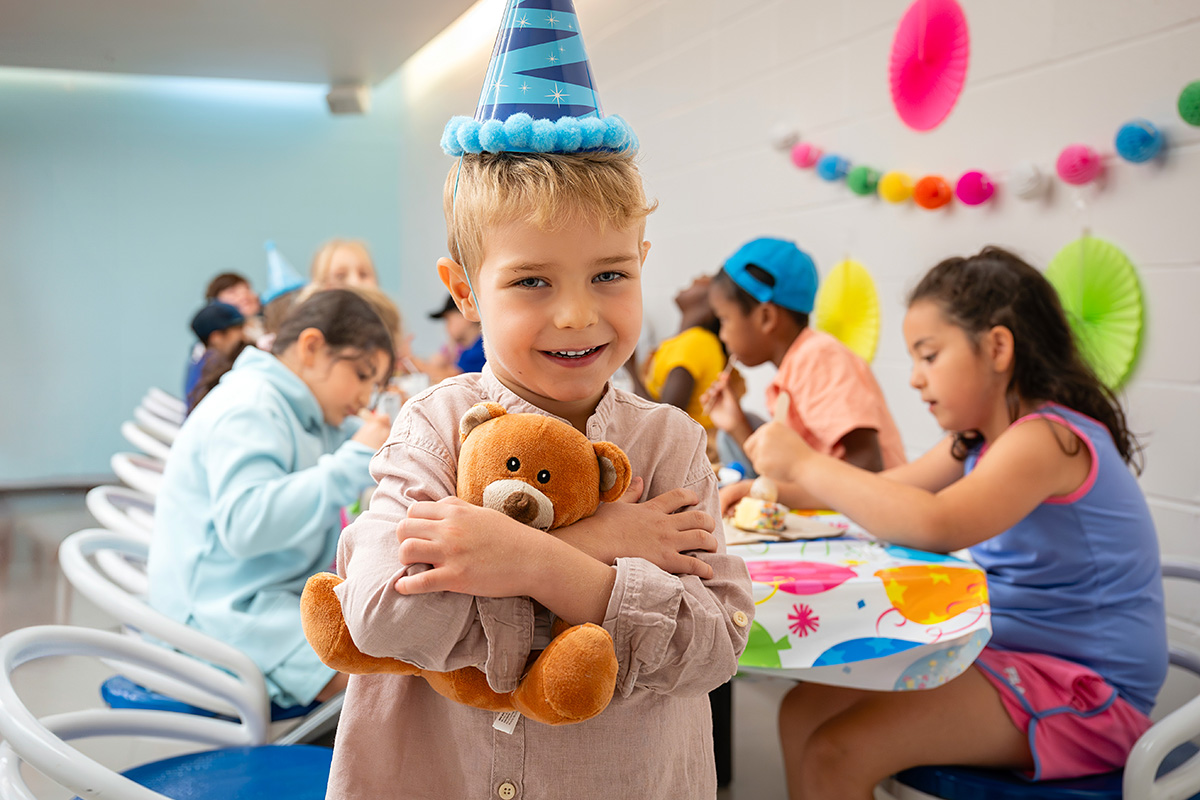 A child and a stuffed bear