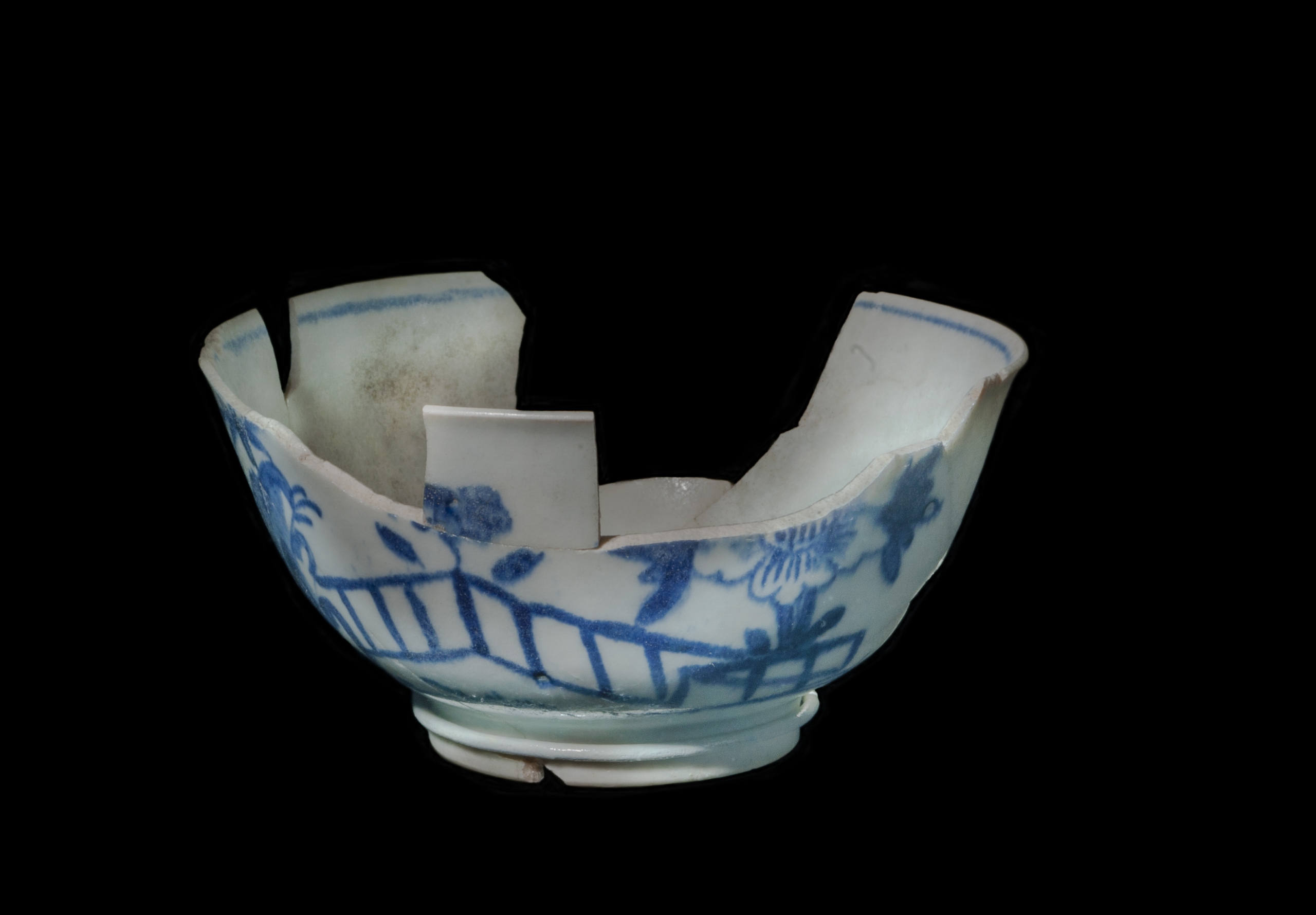 Image of a broken antique blue and white china teacup