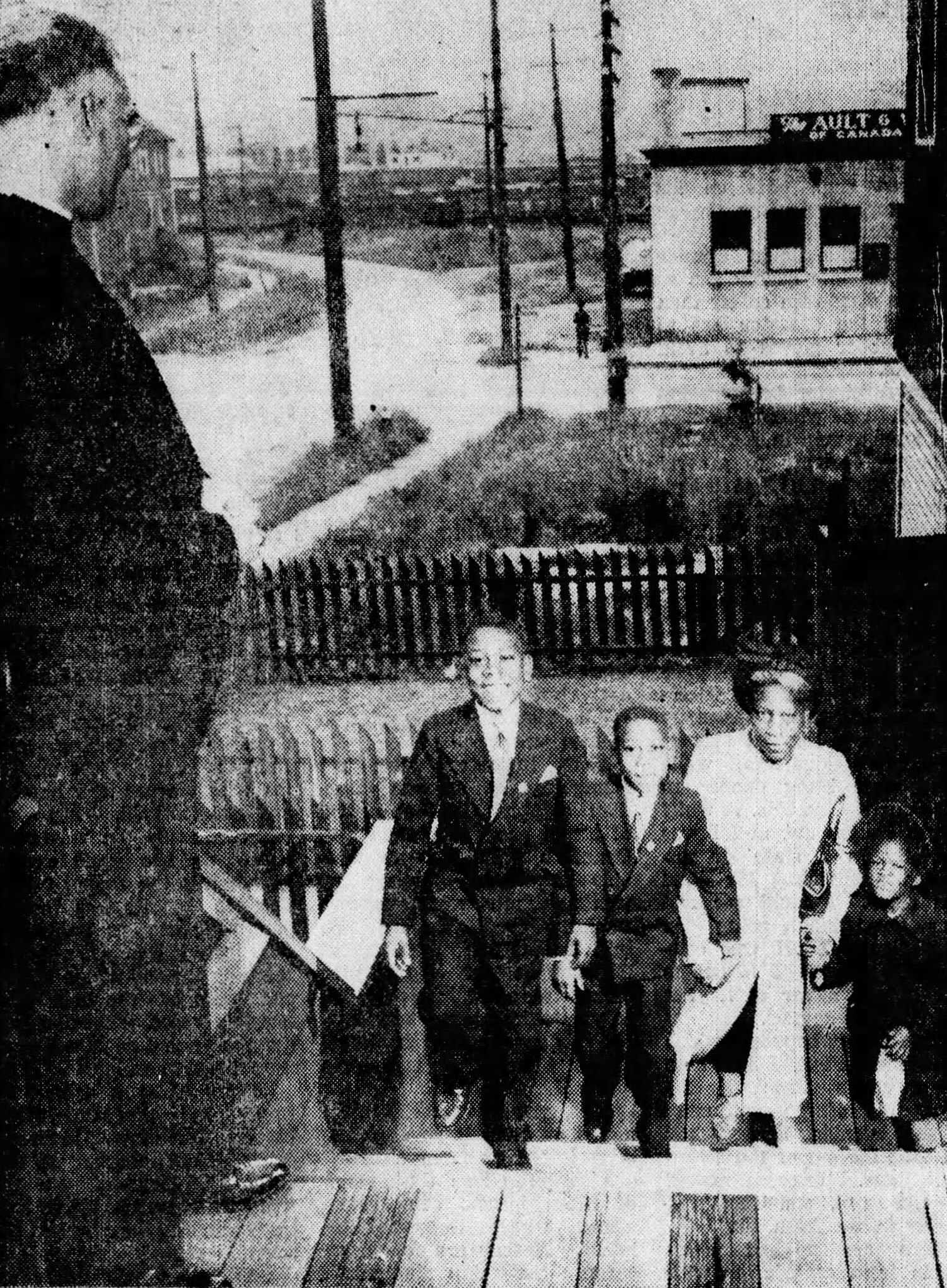 Black-and-white photograph of children walking up steps into a church building.